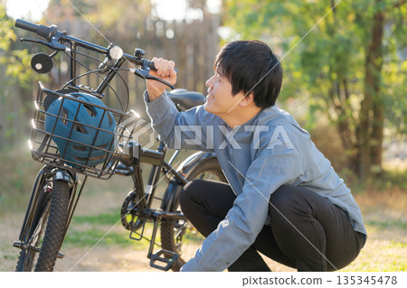 Man doing bicycle maintenance 135345478