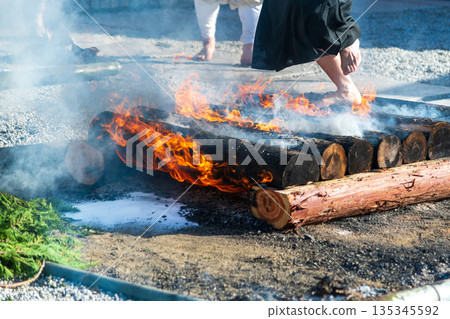 A view of a monk from the knees down performing the fire-walking ritual 135345592