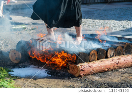 A view of a monk from the knees down performing the fire-walking ritual A view of a monk from the knees down performing the fire-walking ritual 135345593