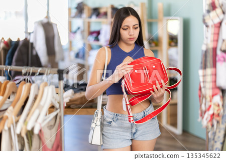 Young women choosing handbag in store 135345622