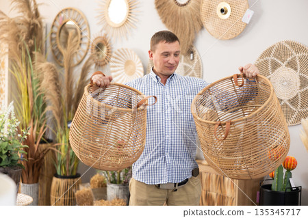 Man looking for functional spacious wicker baskets at store Man looking for functional spacious wicker baskets at store 135345717