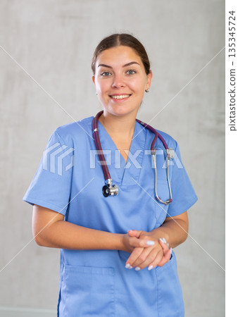 Young woman posing in medical uniform in studio Young woman posing in medical uniform in studio 135345724