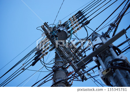 The complex electric poles and wires in a Japanese city The complex electric poles and wires in a Japanese city 135345781