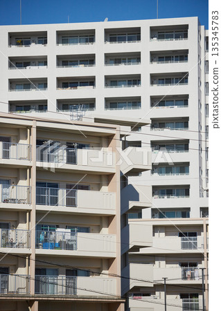 Apartment building in a residential area during the day in winter Apartment building in a residential area during the day in winter 135345783