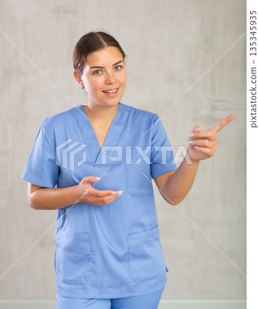 Young woman posing in medical uniform in studio Young woman posing in medical uniform in studio 135345935