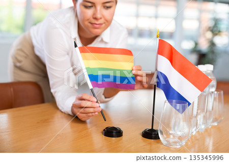 Blurry girl set midget flags of Netherlands and LGBT before international negotiations Blurry girl set midget flags of Netherlands and LGBT before international negotiations 135345996