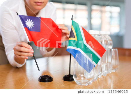 Blurry girl set midget flags of South Africa and Taiwan before international negotiations Blurry girl set midget flags of South Africa and Taiwan before international negotiations 135346015