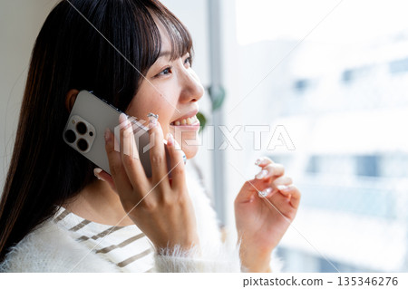Cut of a woman talking on a smartphone Cut of a woman talking on a smartphone 135346276
