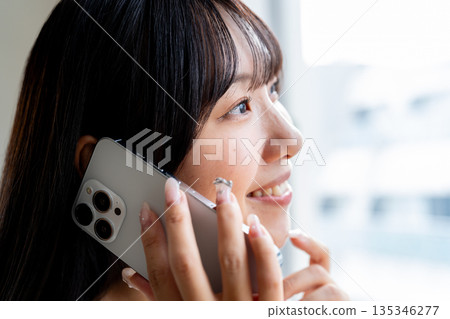 Cut of a woman talking on a smartphone Cut of a woman talking on a smartphone 135346277