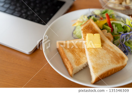 A bird's-eye view of a breakfast scene that evokes working from home or teleworking 135346309