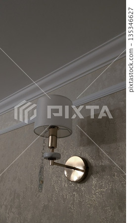Cozy glow from brass wall sconce enhances bedroom atmosphere Cozy glow from brass wall sconce enhances bedroom atmosphere 135346627