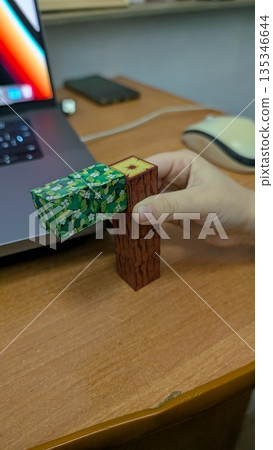 Designer Tests Prototype During Break, Calm Scene Of Designer Testing Tactile Prototype With Wood Blocks Designer Tests Prototype During Break, Calm Scene Of Designer Testing Tactile Prototype With Wood Blocks 135346644