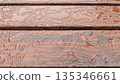 Moody city park bench with wet wooden planks displaying grain 135346661