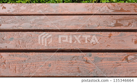 Freshly washed table with water pools and colorful garden scenery Freshly washed table with water pools and colorful garden scenery 135346664