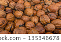 Scattered walnuts with rough shells suggest organic farm freshness 135346678