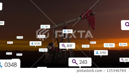 Standing oil pump jack displaying floating search, message and user icons on flat plain at sunset Standing oil pump jack displaying floating search, message and user icons on flat plain at sunset 135346769