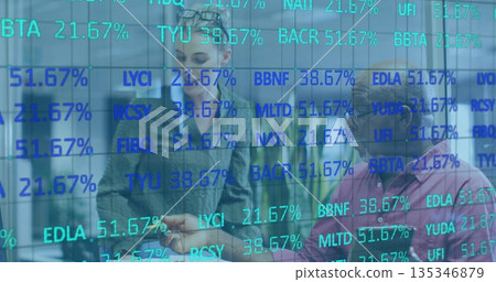 Two analysts in office attire discussing stock percentages in workspace, with digital glass board 135346879