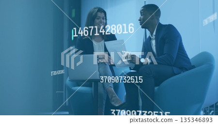 Examining floating data overlays coworkers sitting in office lounge, with laptop and tablet Examining floating data overlays coworkers sitting in office lounge, with laptop and tablet 135346893