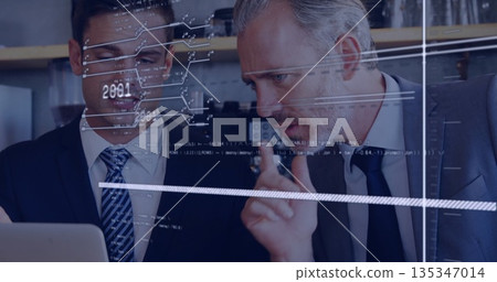 Pointing senior professional and partner analyzing laptop screen in office corner with data overlay Pointing senior professional and partner analyzing laptop screen in office corner with data overlay 135347014