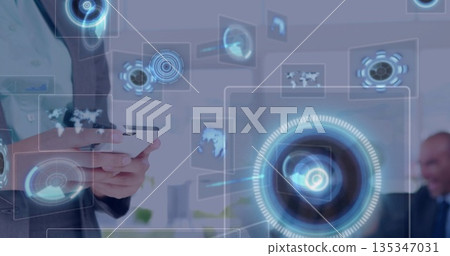 Holding smartphone, business executive manipulating holographic interface in office, copy space 135347031