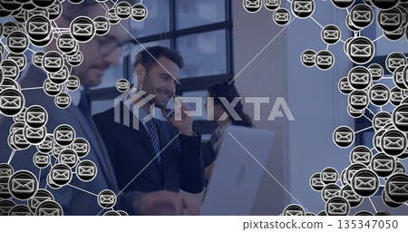 Speaking professional in business suit at office holding smartphone, with laptop and envelope icons Speaking professional in business suit at office holding smartphone, with laptop and envelope icons 135347050