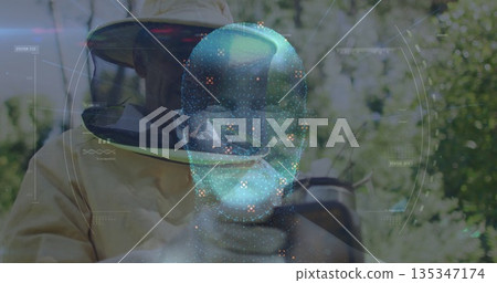 Examining beekeeper wearing suit and gloves observing hive frame in grove, with AR hologram Examining beekeeper wearing suit and gloves observing hive frame in grove, with AR hologram 135347174