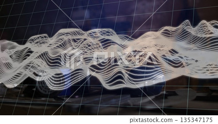 Displaying semi-transparent grid and white dotted waveform hovering over office desk, with keyboard 135347175
