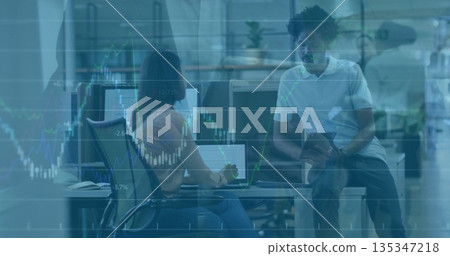 Colleagues analyzing monitor data and consulting tablet at office desk, overlaying financial charts Colleagues analyzing monitor data and consulting tablet at office desk, overlaying financial charts 135347218