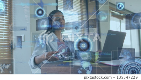 Reaching woman adjusting eyeglasses while working on laptop in office, with holographic data charts Reaching woman adjusting eyeglasses while working on laptop in office, with holographic data charts 135347229