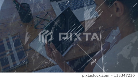 Mature woman reviewing tablet data at office desk, with laptop notebook glasses pens, copy space Mature woman reviewing tablet data at office desk, with laptop notebook glasses pens, copy space 135347230