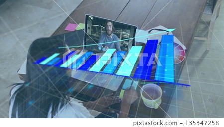 Working designer analyzing holographic bar chart on laptop in home office with color swatch palette Working designer analyzing holographic bar chart on laptop in home office with color swatch palette 135347258