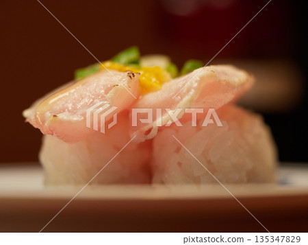 A close-up photo of the restaurant's delicious grilled albacore fatty tuna sushi with yuzu salt A close-up photo of the restaurant's delicious grilled albacore fatty tuna sushi with yuzu salt 135347829