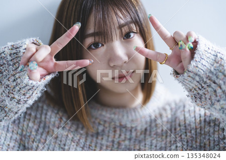 woman doing peace sign 135348024