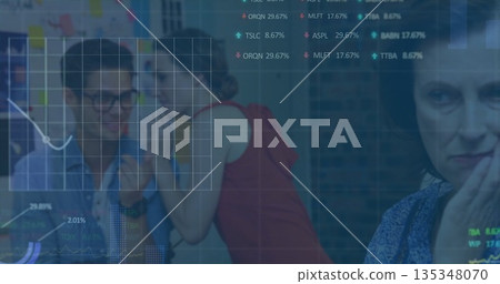 Coworkers whispering under charts overlay at office, with sticky notes on partition, copy space 135348070