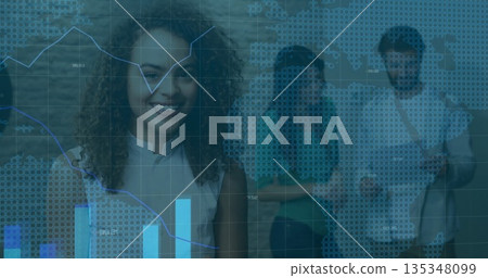 Standing woman with curly hair observing digital data overlays in studio with smartphone and charts 135348099