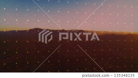 Displaying remote desert plateau silhouette at dusk, with translucent glowing square grid overlay 135348135