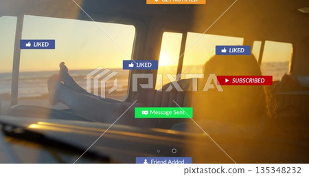 Reclining barefoot woman gazing toward ocean horizon inside beach van, with social media overlays 135348232