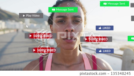 Standing female athlete in pink sports top on boardwalk, showcasing subscribe buttons and play icon Standing female athlete in pink sports top on boardwalk, showcasing subscribe buttons and play icon 135348245