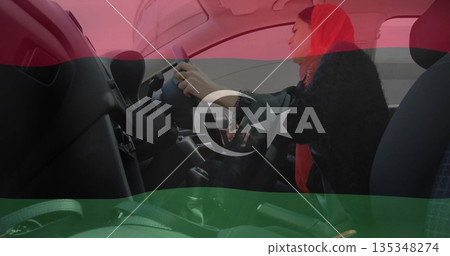 Gripping steering wheel woman wearing red hijab driving urban car cabin with seat belt, copy space 135348274