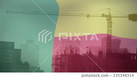 Rising tower crane stretching above scaffolding and framework at city skyline, pastel overlays 135348314
