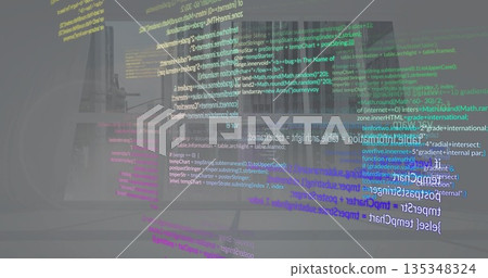 Floating holographic code streams rising above laptop computer at office desk, color overlays Floating holographic code streams rising above laptop computer at office desk, color overlays 135348324
