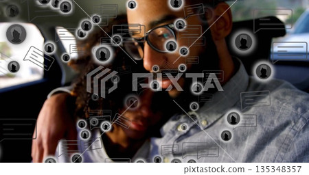 Leaning couple wearing glasses cuddling on car back seat, with floating chat icons Leaning couple wearing glasses cuddling on car back seat, with floating chat icons 135348357