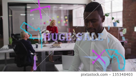 Standing man in white shirt planning at office, with glass doodles reading HUGE SALE, copy space 135348403