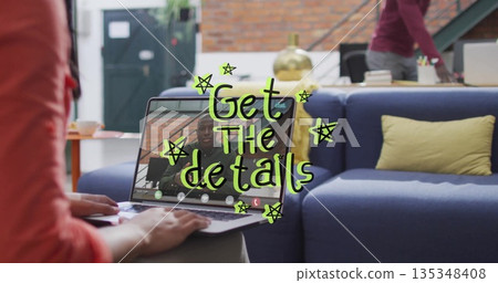 Working woman wearing red top conducting remote call on laptop in office lounge, with brass lamp 135348408