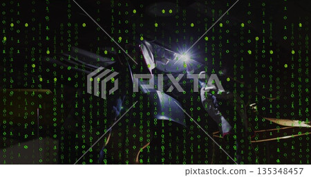 Leaning female welder welding workpiece at workshop, with torch, helmet, gloves and binary overlay 135348457