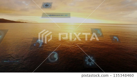 Displaying golden ocean glowing at seaside sunset, with holographic schematics and waveform panel 135348460