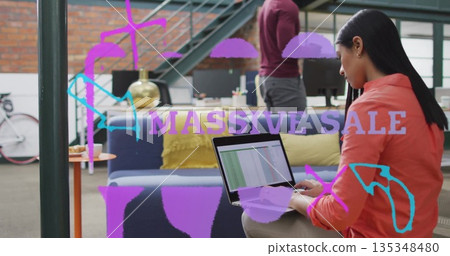 Typing Asian woman wearing orange shirt on laptop in loft office with monitors, copy space Typing Asian woman wearing orange shirt on laptop in loft office with monitors, copy space 135348480