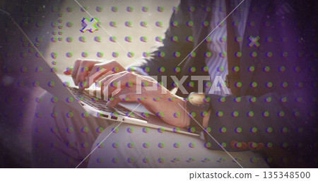 Typing business man wearing blazer striped shirt in lounge, with silver laptop and metallic watch Typing business man wearing blazer striped shirt in lounge, with silver laptop and metallic watch 135348500
