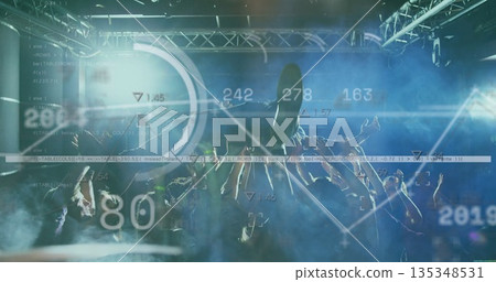 Cheering crowd raising smartphones under metal truss and colored beams at venue, with data overlays 135348531