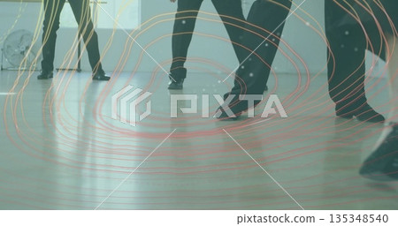 Practicing dancers in black dance shoes coordinating footwork in studio, with fan and digital lines 135348540